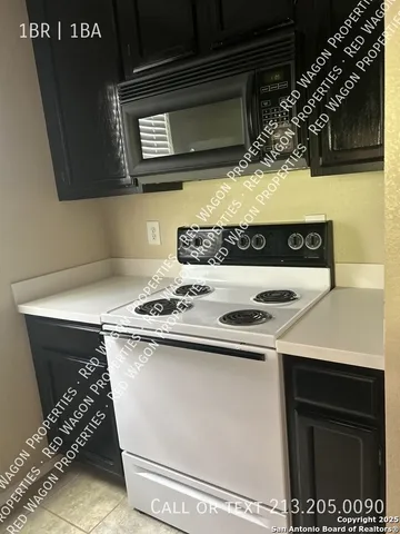 a kitchen with a stove and a microwave
