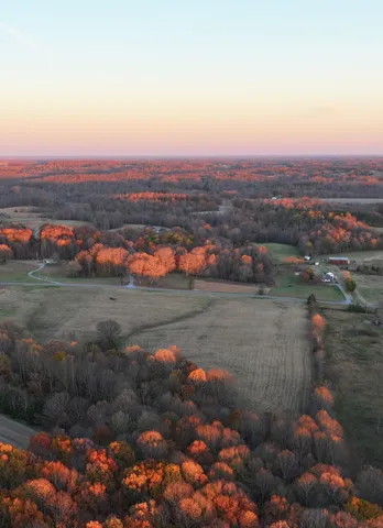 an aerial view of a houses with city view