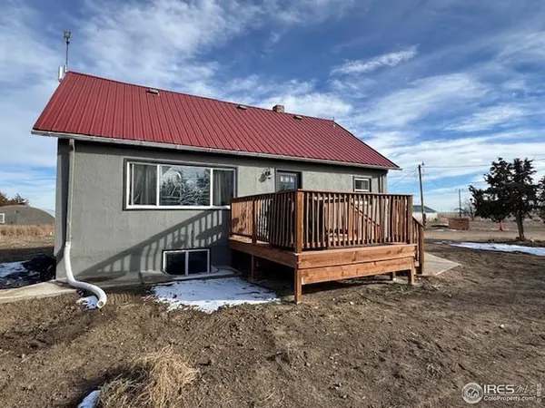 a view of backyard with deck and outdoor seating