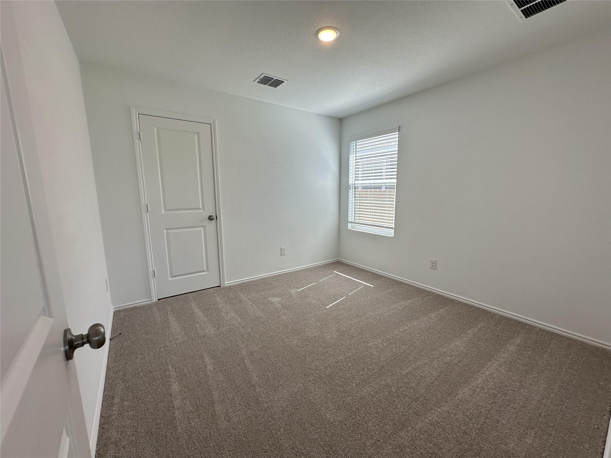 233 Magalia Lane Kyle, TX 78640 - Photo 17 of 37 Carpeted empty room featuring baseboards