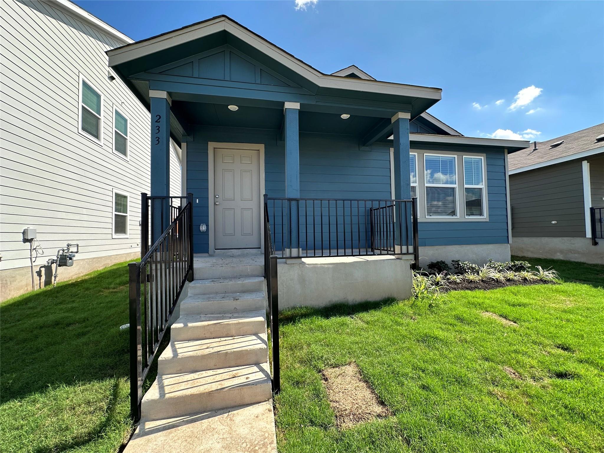 233 Magalia Lane Kyle, TX 78640 - Photo 2 of 37 View of exterior entry featuring a lawn, a porch, and board and batten siding