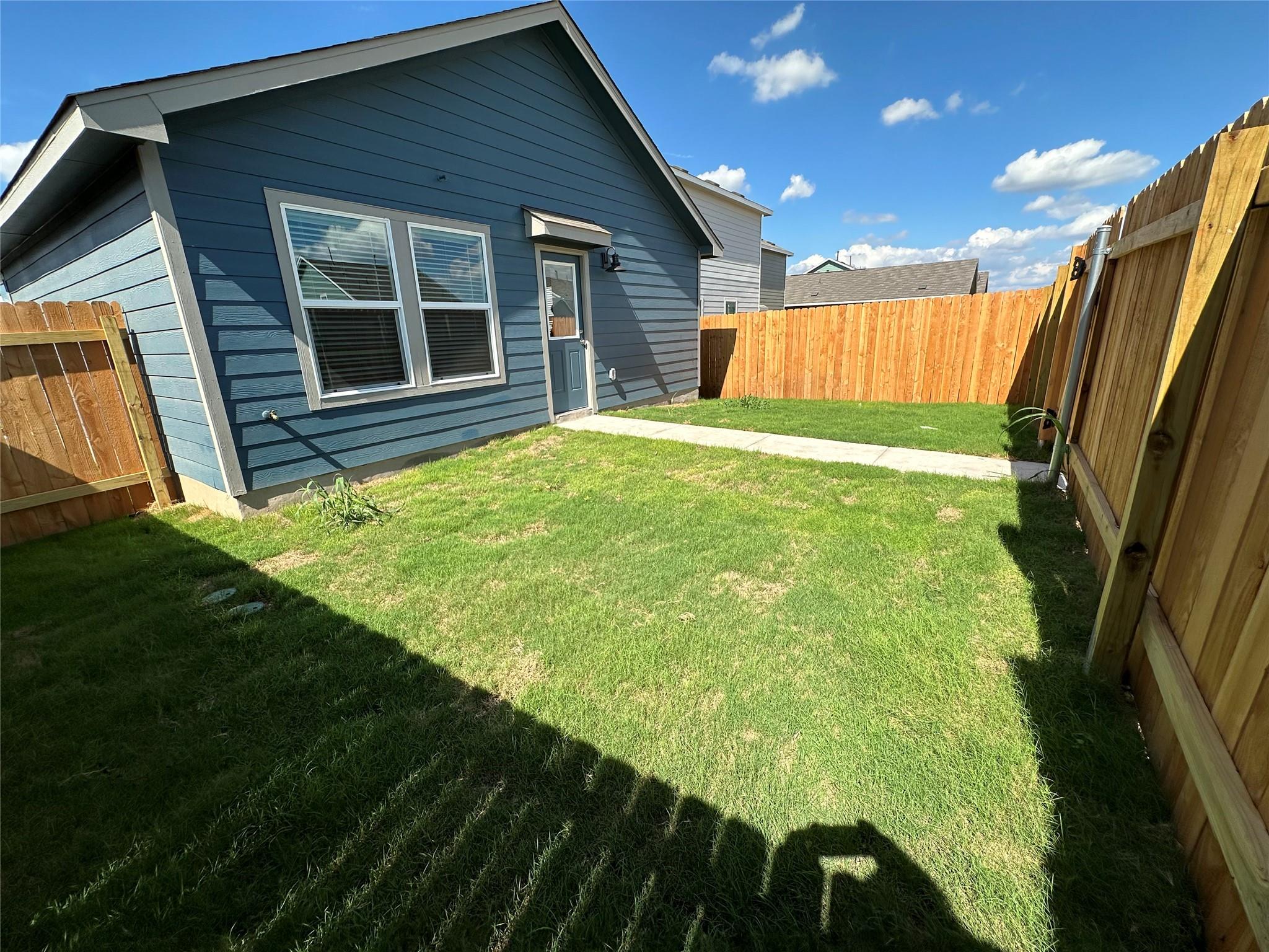 233 Magalia Lane Kyle, TX 78640 - Photo 29 of 37 Rear view of house with a fenced backyard