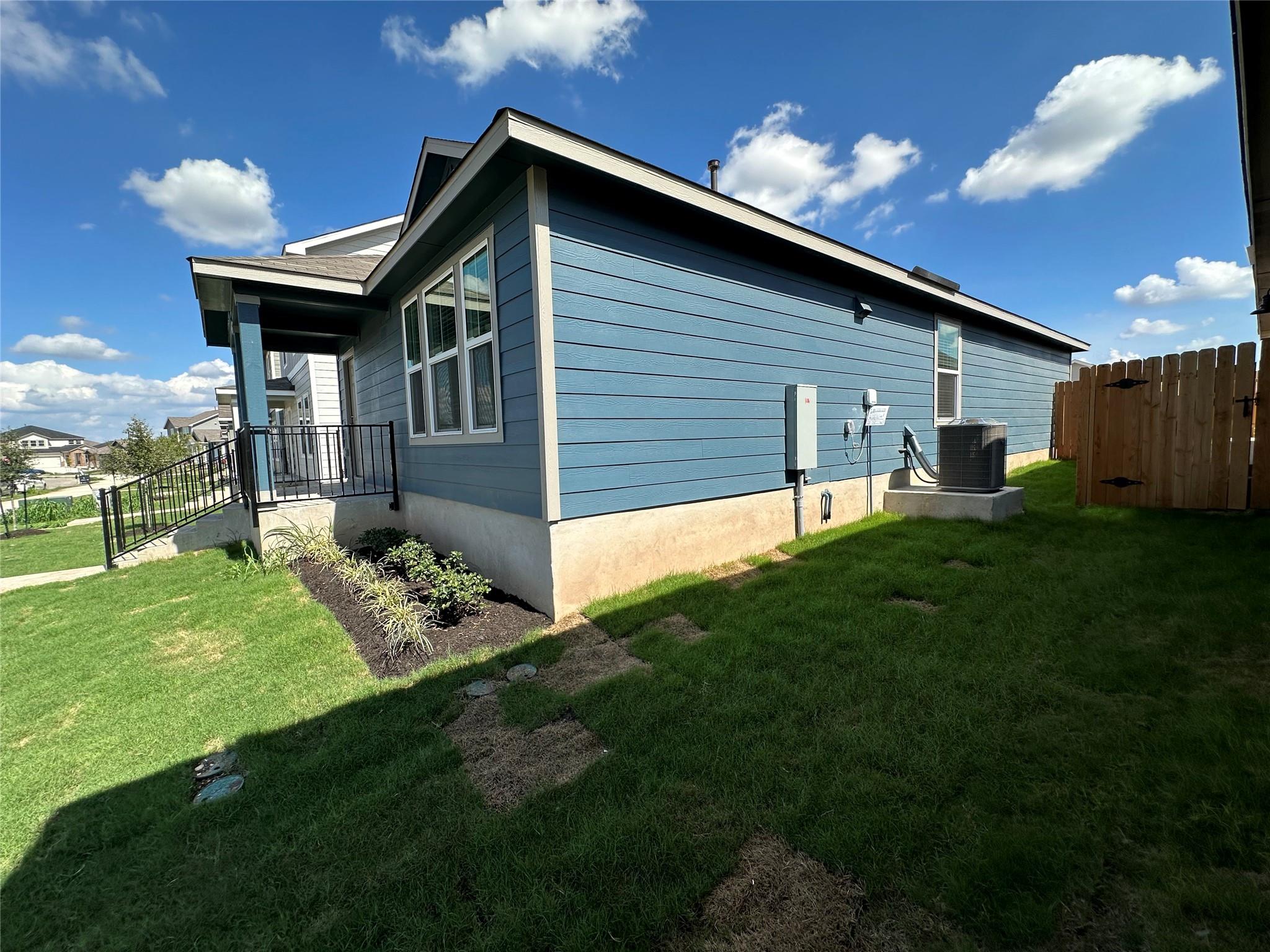 233 Magalia Lane Kyle, TX 78640 - Photo 32 of 37 View of side of home featuring a cooling unit