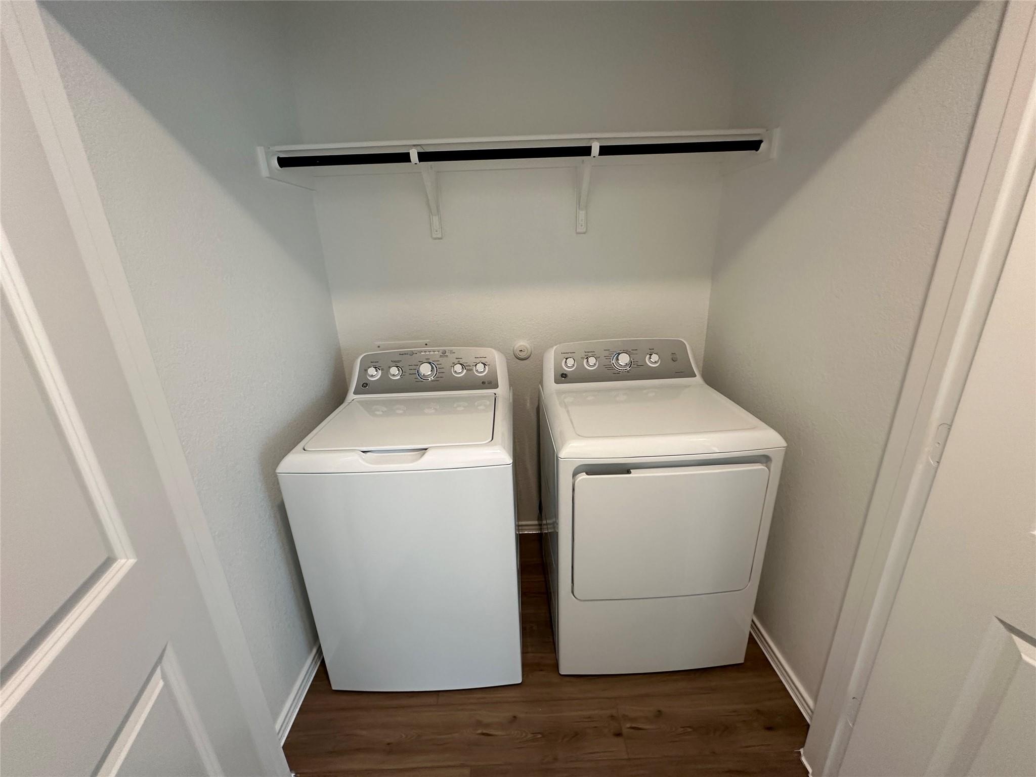 233 Magalia Lane Kyle, TX 78640 - Photo 4 of 37 Laundry area featuring dark wood-style floors and washer and clothes dryer