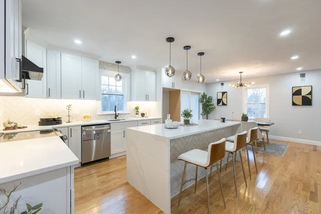 a kitchen with appliances a sink a counter top space and cabinets