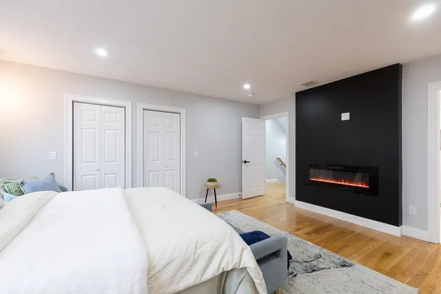 a spacious bedroom with a bed and a fireplace