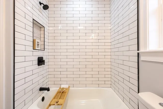a bathroom with a bathtub and shower