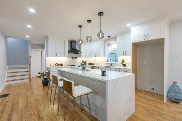 a kitchen with stainless steel appliances granite countertop a sink and a refrigerator