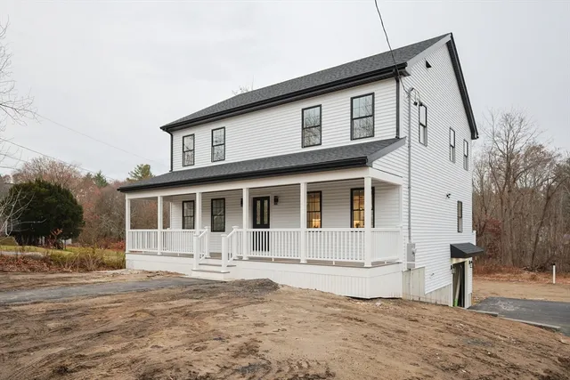 a front view of a house with a yard and balcony