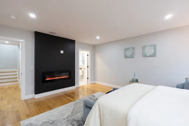 a bedroom with a bed and a fireplace