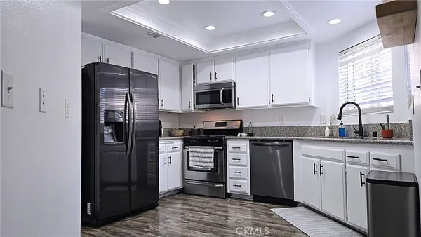 a kitchen with stainless steel appliances granite countertop a refrigerator stove and sink