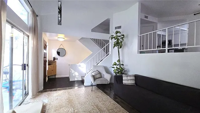 a living room with furniture and a potted plant