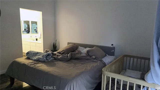 a large bed sitting in a bedroom next to a window