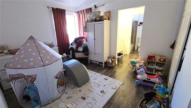 a bedroom with bed and a chandelier