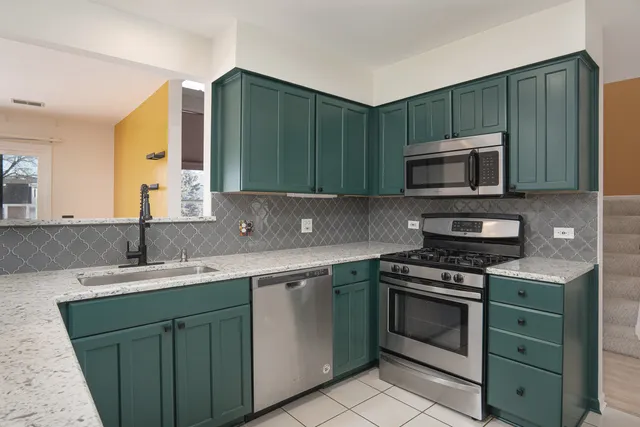 a kitchen with a sink stove and microwave
