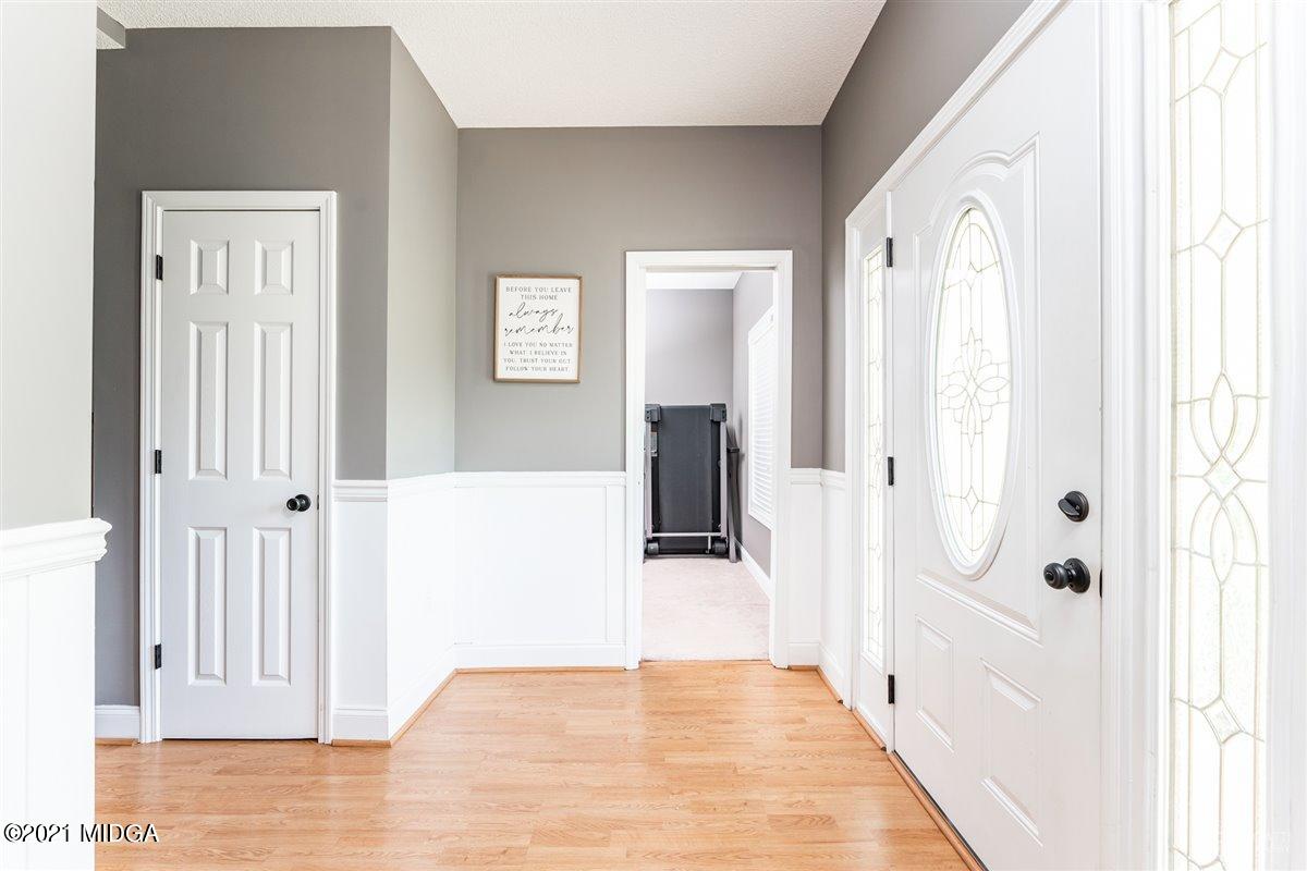 1900 Smith Road Forsyth, GA 31029 - Photo 2 of 28 a view of a hallway with wooden floor and staircase