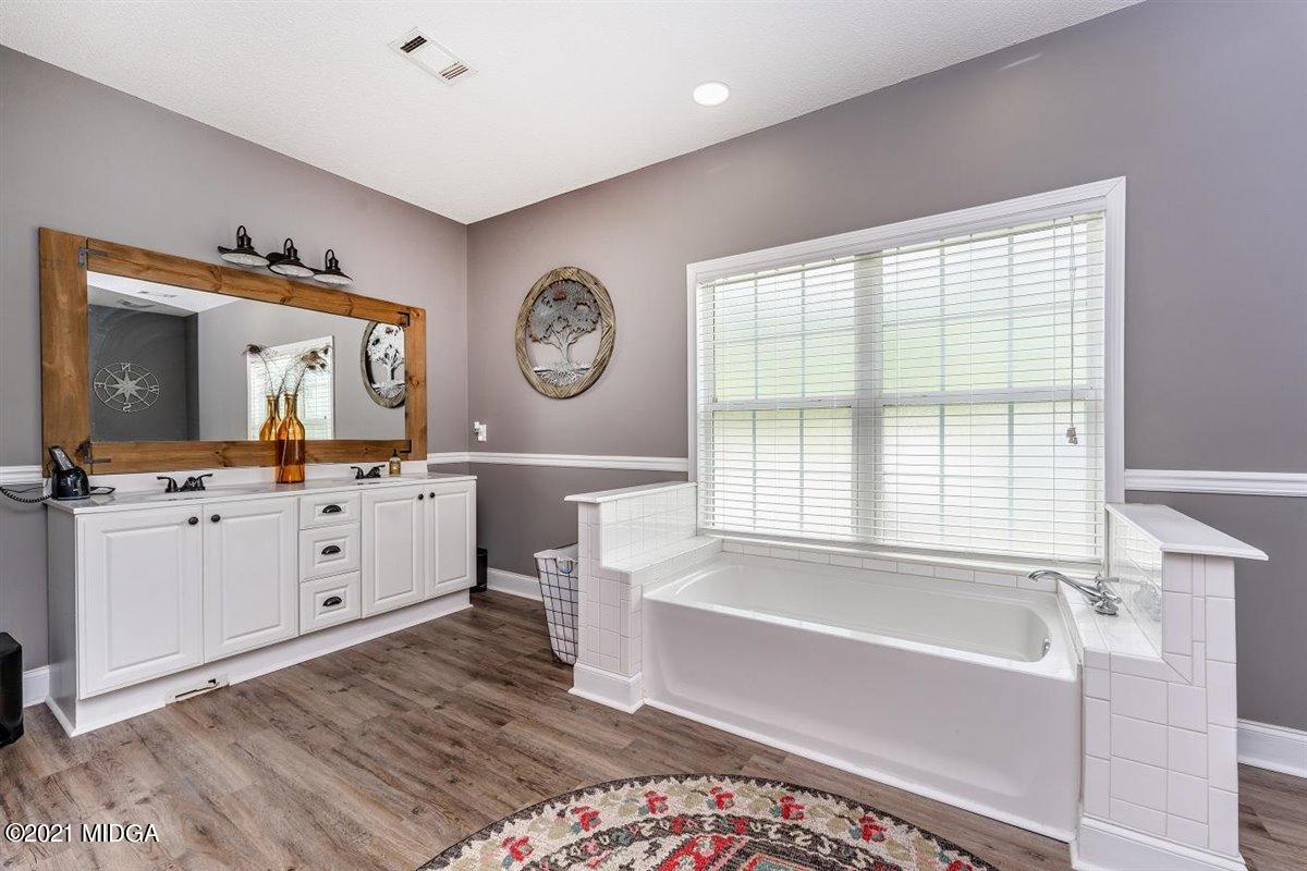 1900 Smith Road Forsyth, GA 31029 - Photo 12 of 28 a bathroom with a double vanity sink mirror and bathtub