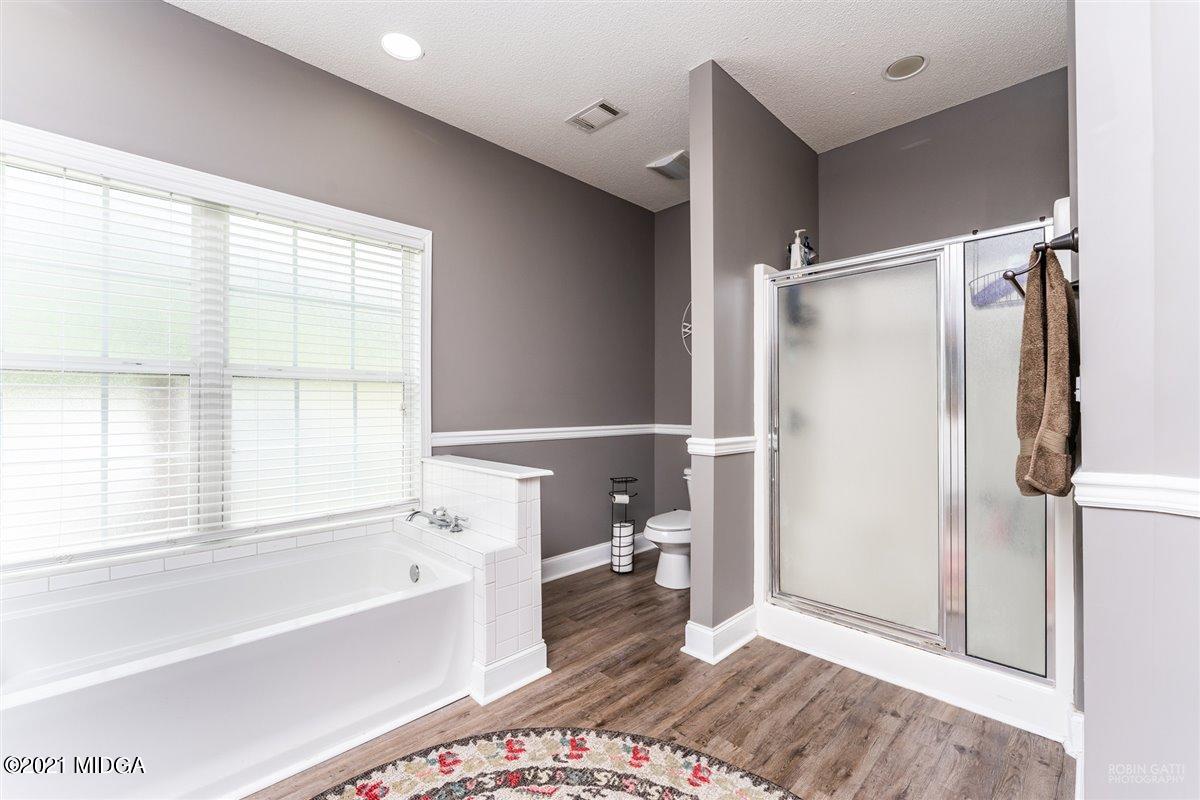 1900 Smith Road Forsyth, GA 31029 - Photo 13 of 28 a bathroom with a bathtub and a shower
