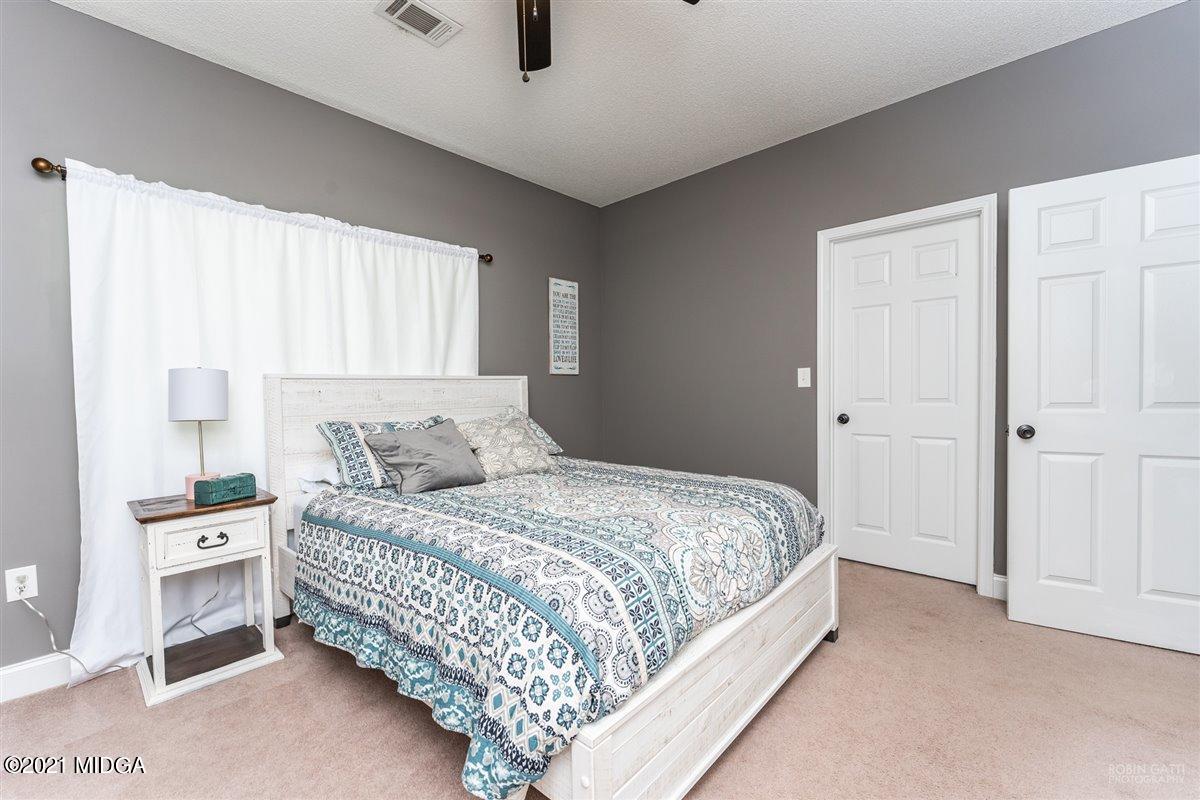 1900 Smith Road Forsyth, GA 31029 - Photo 14 of 28 a bedroom with a bed and a cabinets