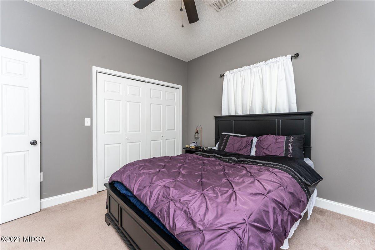 1900 Smith Road Forsyth, GA 31029 - Photo 15 of 28 a bedroom with a large bed and a window