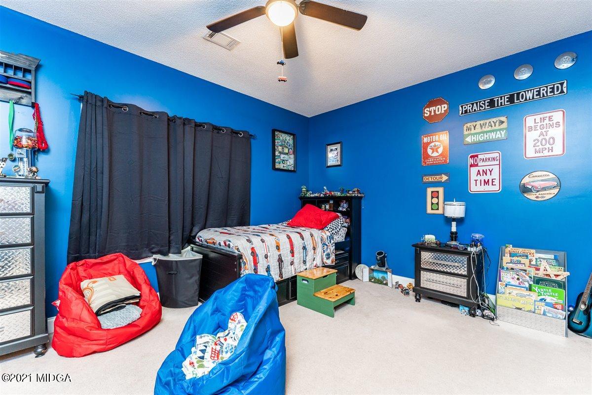 1900 Smith Road Forsyth, GA 31029 - Photo 16 of 28 a bedroom with furniture and a lamp