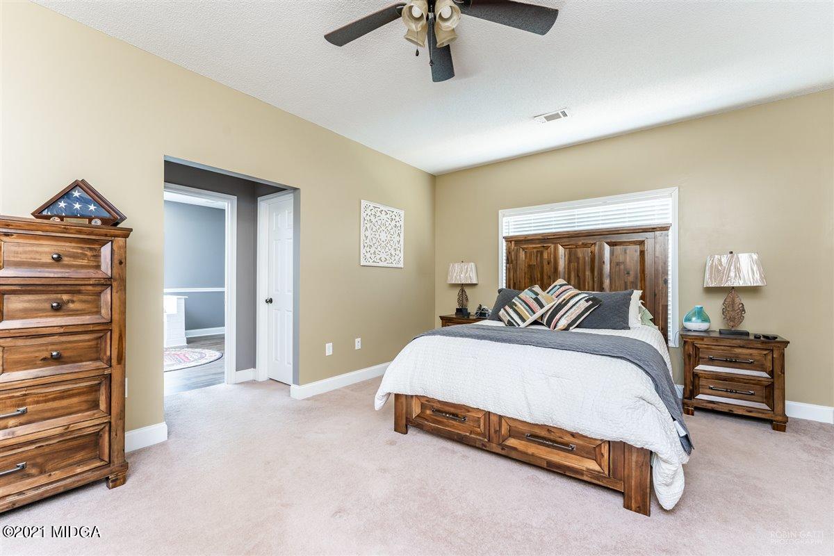 1900 Smith Road Forsyth, GA 31029 - Photo 10 of 28 a bedroom with a bed and dresser