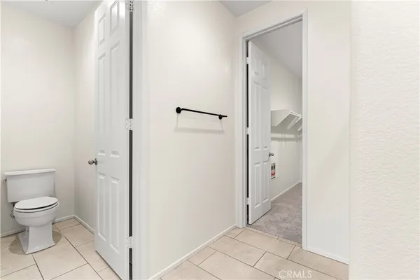 a bathroom with a granite countertop toilet and a shower