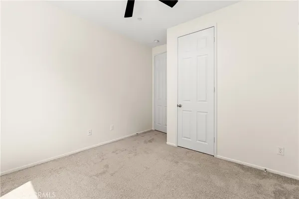 an empty room with a ceiling fan