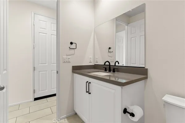 a bathroom with a granite countertop sink and mirror