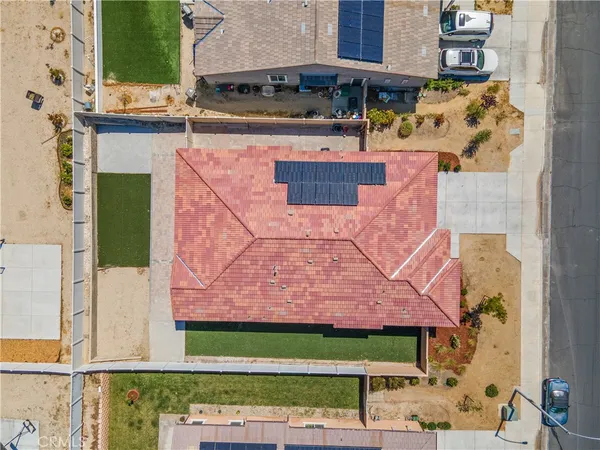 an aerial view of a house with a yard