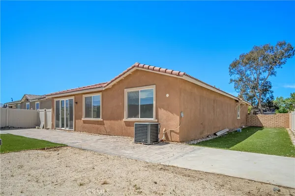 a front view of a house with a garden and yard