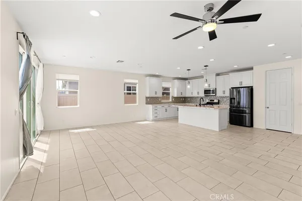 a view of a kitchen with a sink and a refrigerator