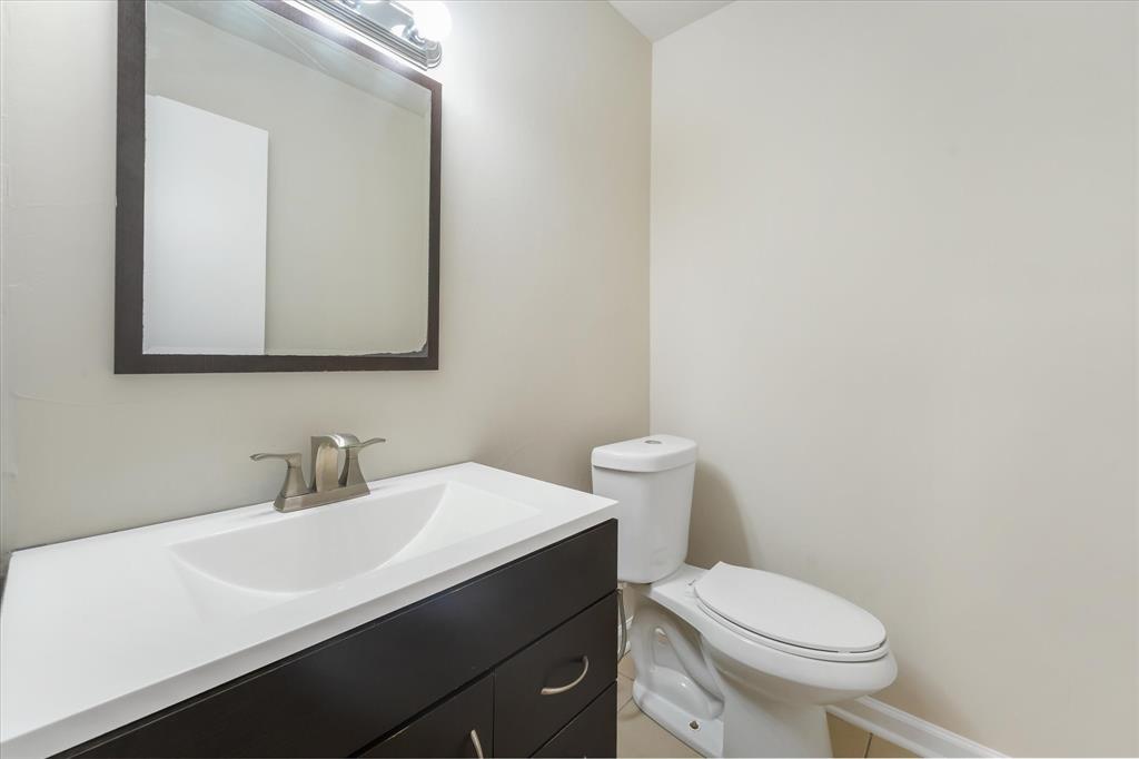 304 East Stone Road Wylie, TX 75098 - Photo 10 of 19 a bathroom with a sink a toilet and mirror