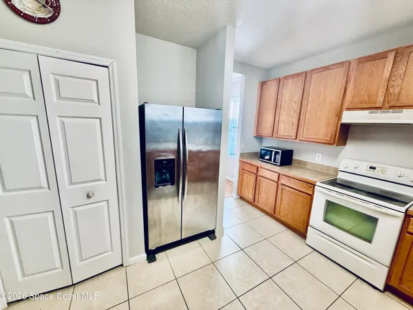 a kitchen with stainless steel appliances a refrigerator sink and cabinets