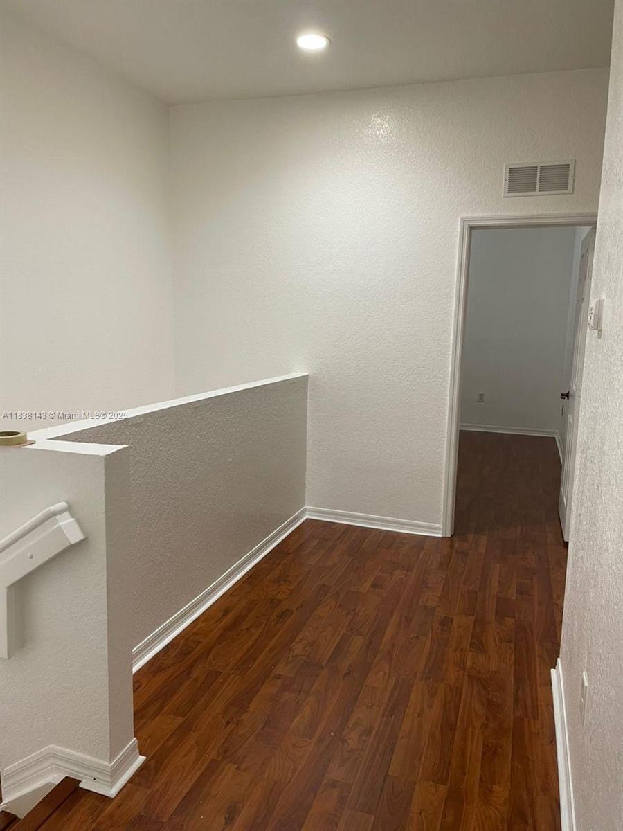 4911 Southwest 140th Terrace, Unit 6 Miramar, FL 33027 - Photo 5 of 14 a view of an empty room with wooden floor