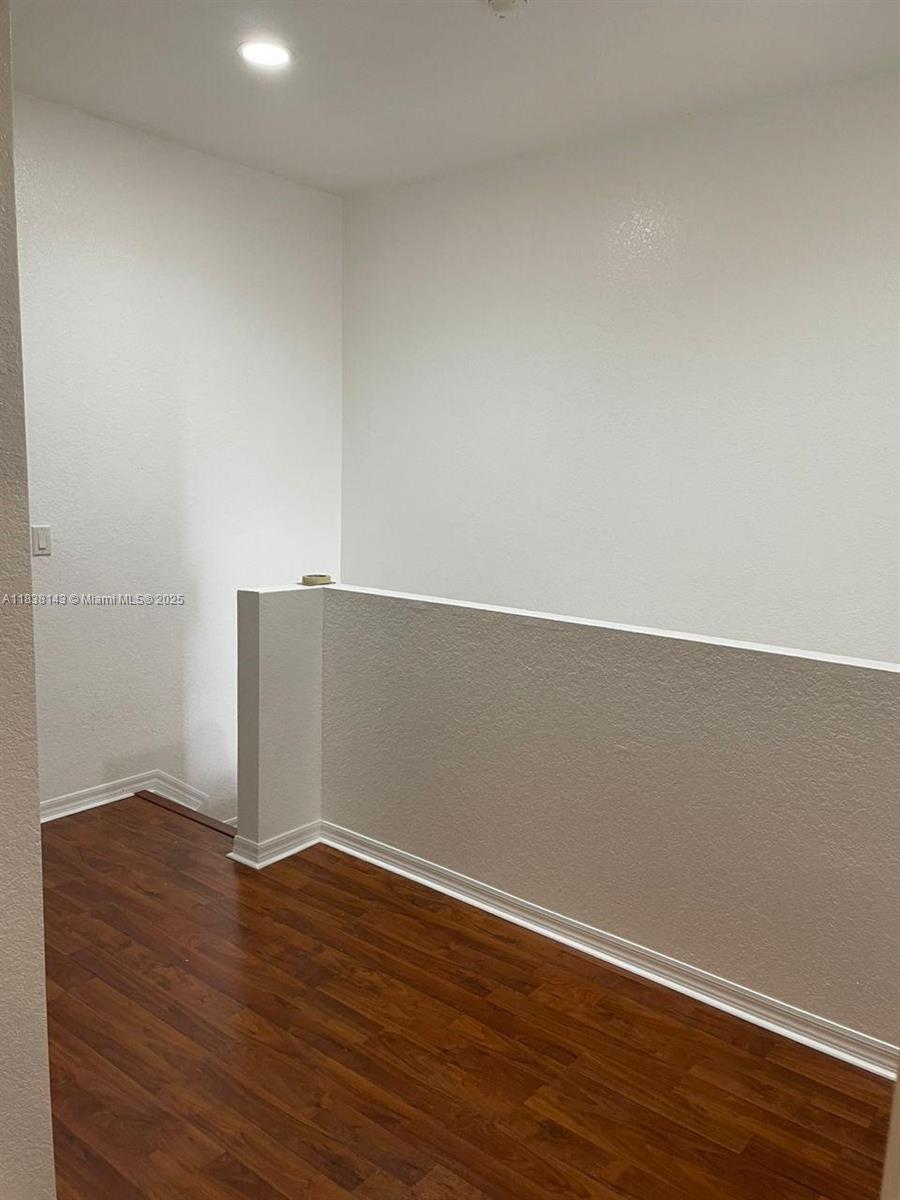 4911 Southwest 140th Terrace, Unit 6 Miramar, FL 33027 - Photo 6 of 14 a view of an empty room with wooden floor