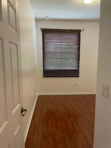 a view of a small space with wooden floor and staircase