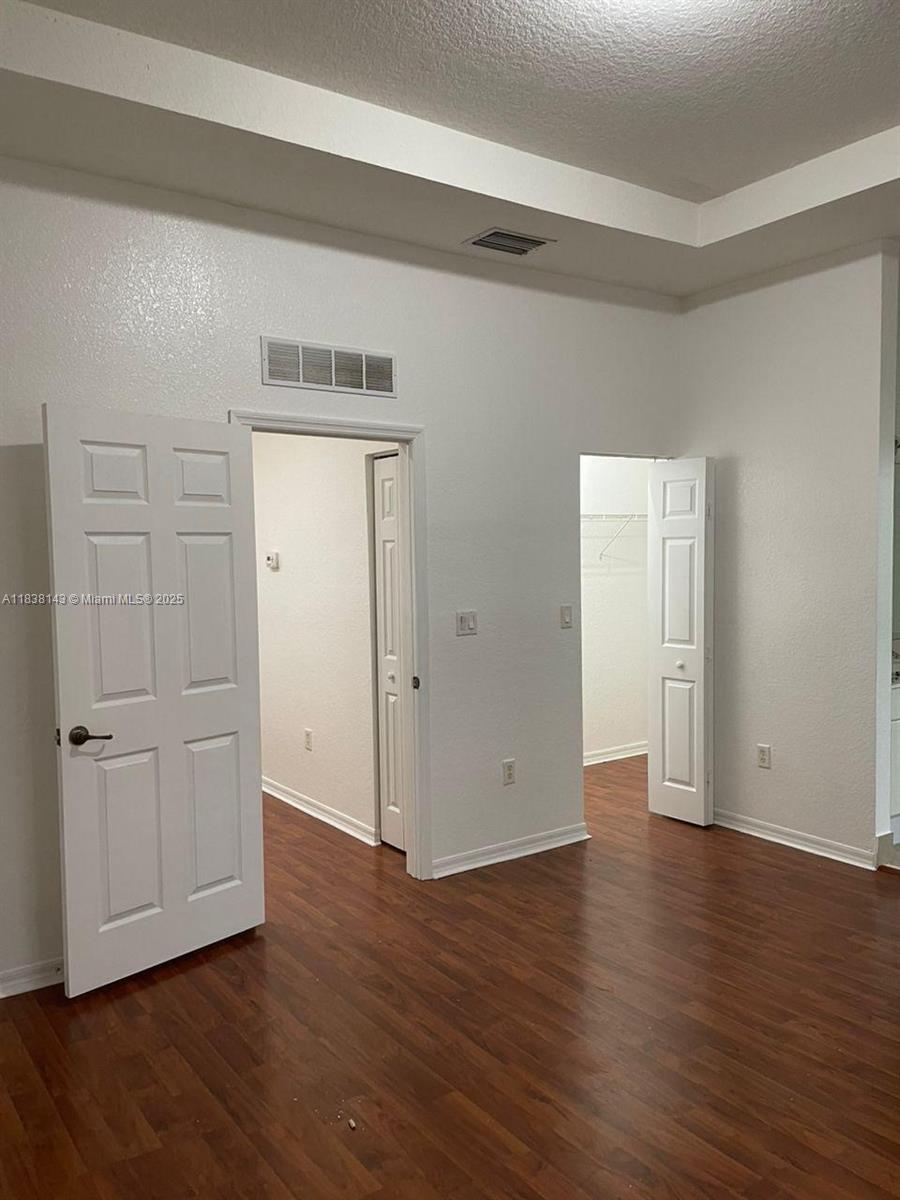 4911 Southwest 140th Terrace, Unit 6 Miramar, FL 33027 - Photo 10 of 14 an empty room with wooden floor & closet area