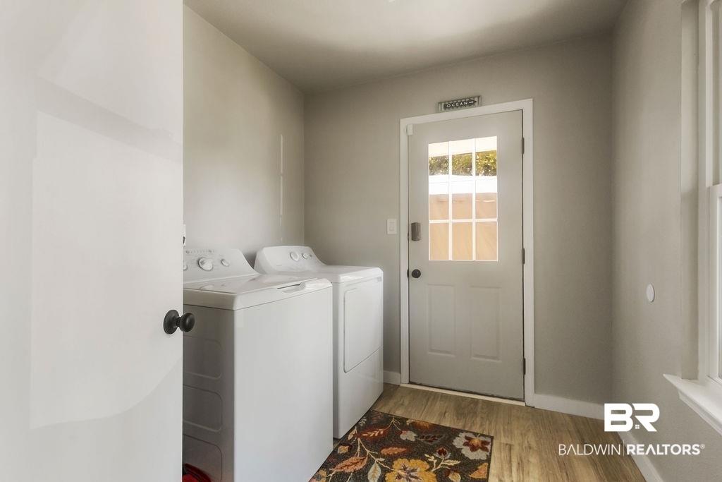 601 East Gate Circle Foley, AL 36535 - Photo 26 of 26 Clothes washing area with washing machine and dryer and light hardwood / wood-style floors