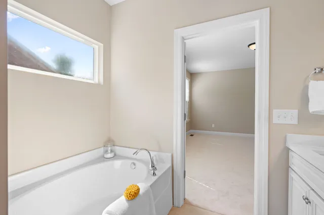 a bathroom with a tub and shower