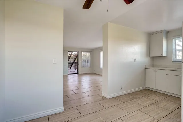 a kitchen with stainless steel appliances a refrigerator a stove and white cabinets