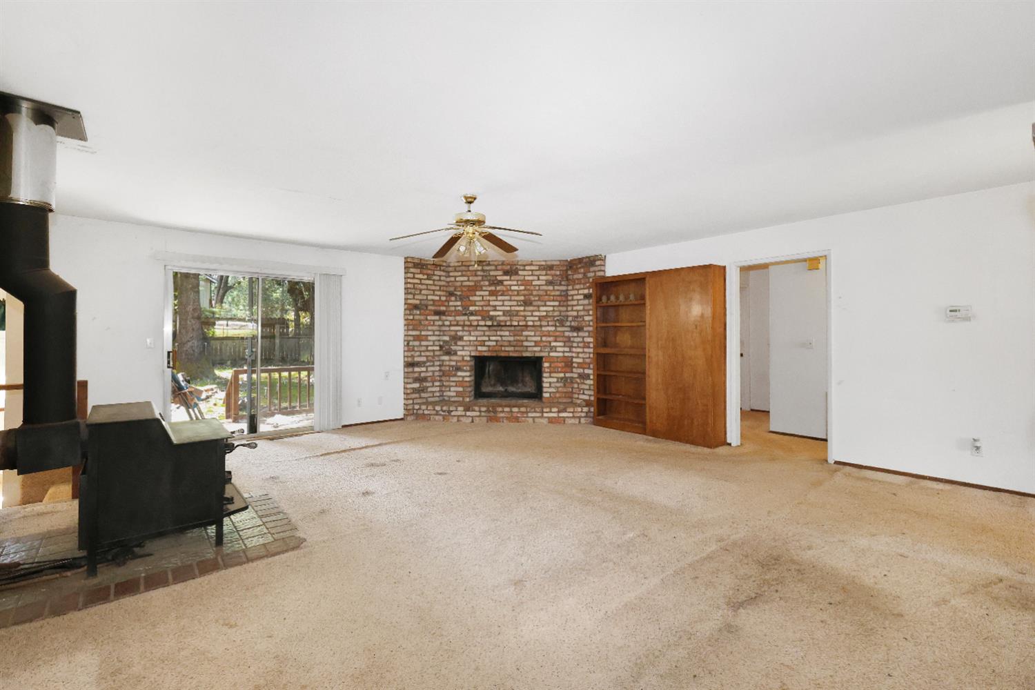 19688 Murphy Road Pine Grove, CA 95665 - Photo 3 of 8 an empty room with furniture and a fireplace