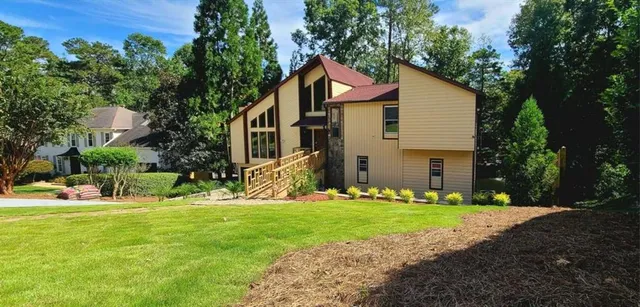 a front view of house with yard and green space
