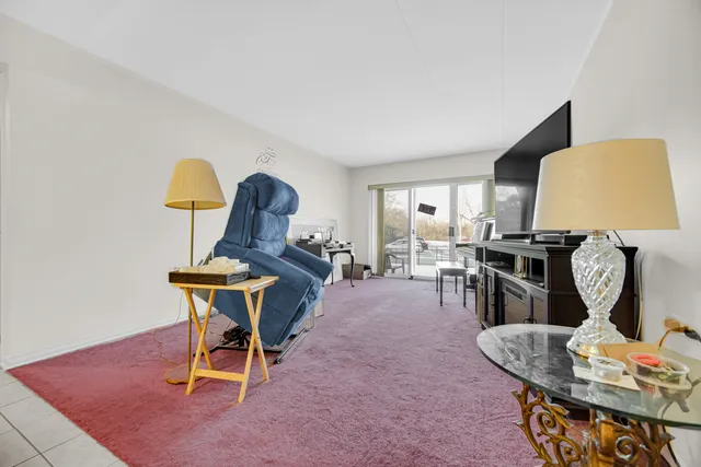 a living room with furniture and a lamp