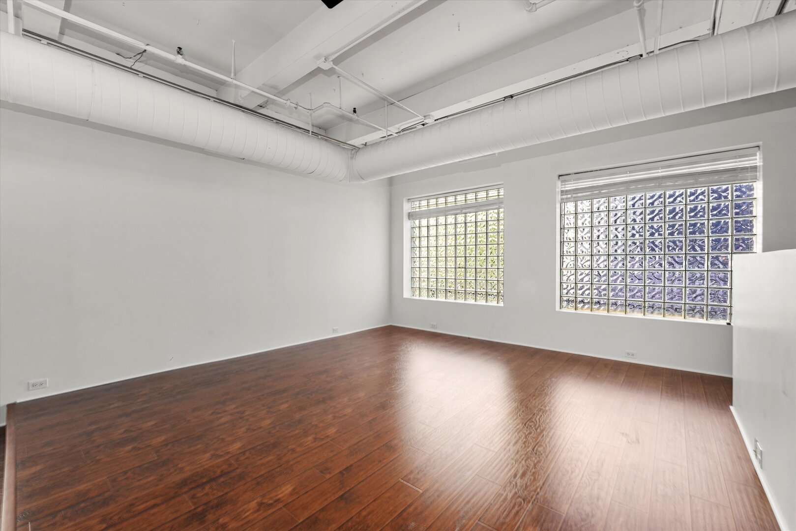 1301 South Wabash Avenue, Unit 1 Chicago, IL 60605 - Photo 17 of 29 a view of an empty room with wooden floor and a window