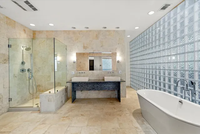 a bathroom with a bathtub and a shower