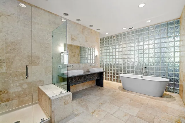 a bathroom with a tub sink toilet and shower