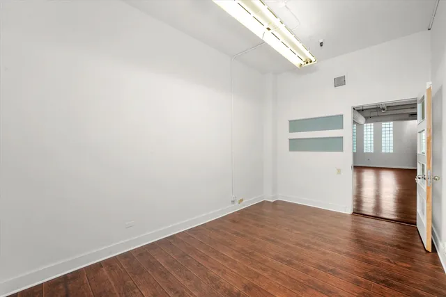a view of empty room with wooden floor