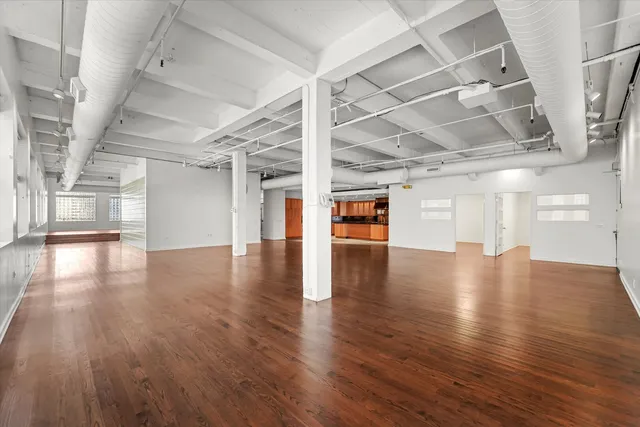 a view of a hall with wooden floors