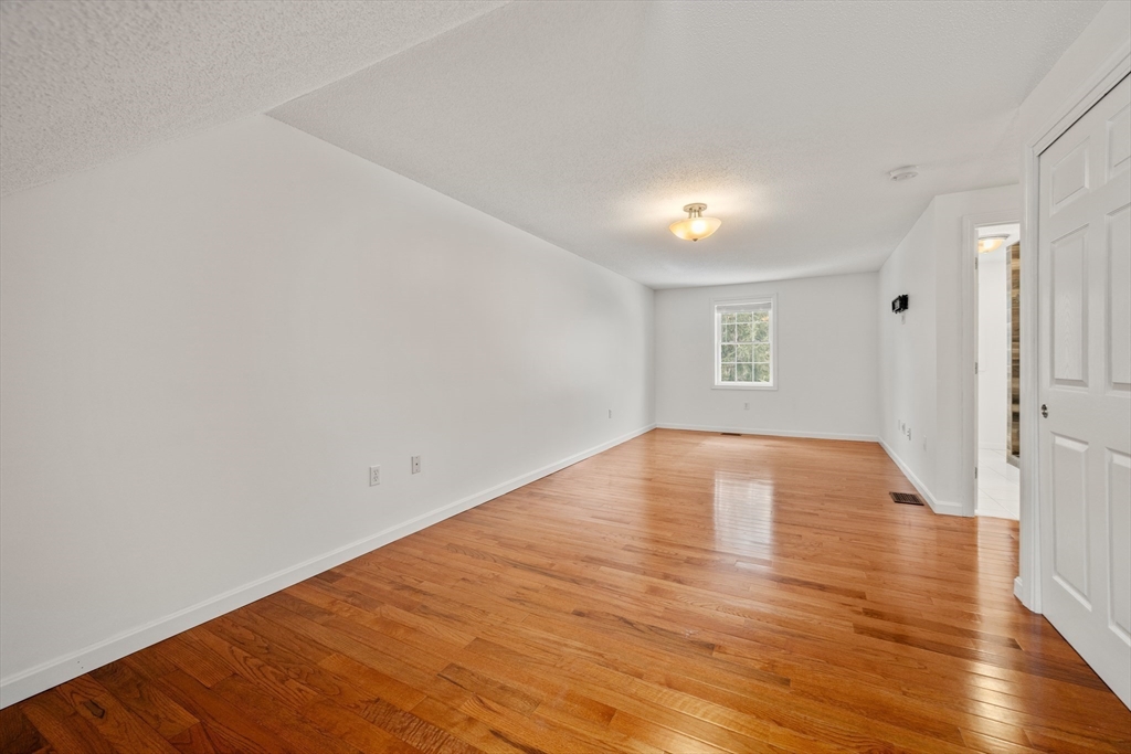 181 High Street, Unit 1 Andover, MA 01810 - Photo 11 of 21 a view of empty room with wooden floor and fan